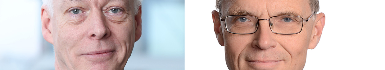 Två män i kostym och slips, tittar in i kameran.